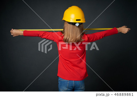 Decoration, renovation and reconstrucion concept. Girl with measuring tape 46889861