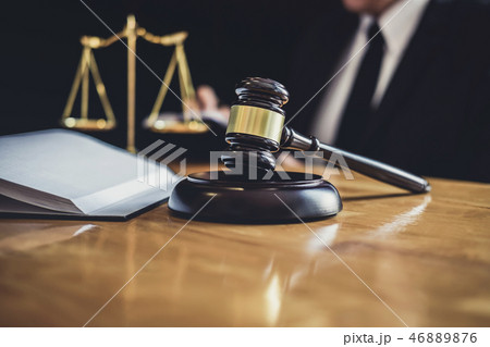 Male lawyer or judge working with contract papers, Law books and 46889876