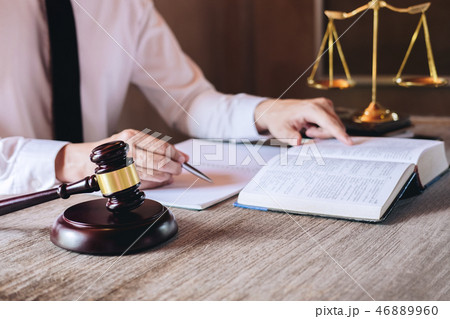 Judge gavel with scales of justice, male lawyers working having Judge gavel with scales of justice, male lawyers working having 46889960