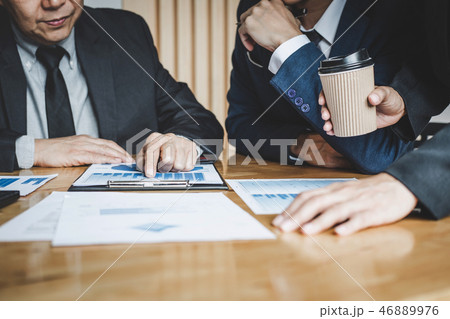 Executive team discussing the charts and graphs working in busin 46889976