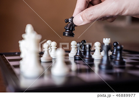 Hand of confident businessman use horse chess piece black playin 46889977