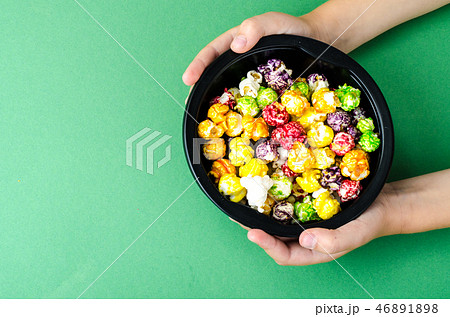 Colorful popcorn in children's hands 46891898