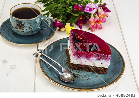 Piece of jelly mousse cake with fruit, cup of tea Piece of jelly mousse cake with fruit, cup of tea 46892483