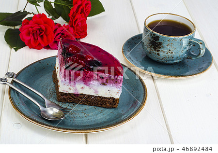 Piece of jelly mousse cake with fruit, cup of tea Piece of jelly mousse cake with fruit, cup of tea 46892484