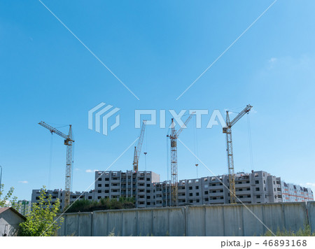 Construction site with many cranes against the sky Construction site with many cranes against the sky 46893168