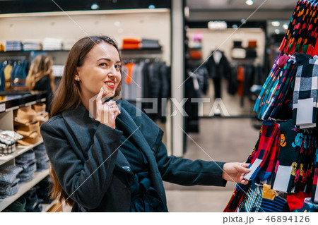 woman searchin for cothes gift in a store supermarket shop 46894126