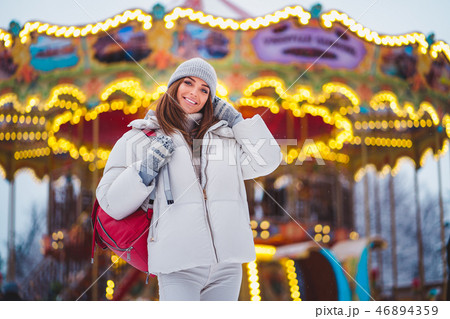 Outdoors lifestyle fashion portrait of stunning girl walking on the holiday city. Outdoors lifestyle fashion portrait of stunning girl walking on the holiday city. 46894359