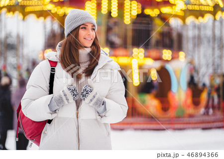 Outdoors lifestyle fashion portrait of stunning girl walking on the holiday city. 46894366
