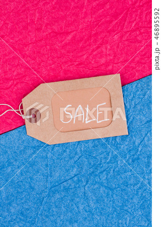 Brown tag with inscription sale on colored background. Brown tag with inscription sale on colored background. 46895592