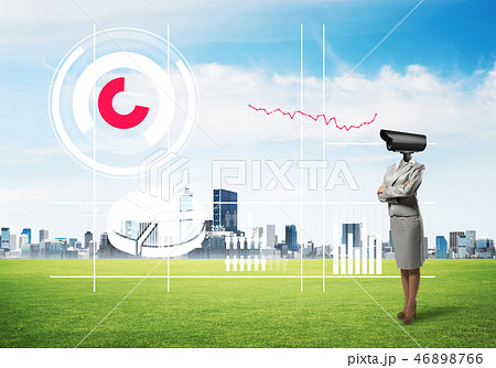 Camera headed woman standing on green grass against modern cityscape 46898766