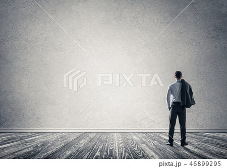 Businessman threw his jacket over his back and looking at blank Businessman threw his jacket over his back and looking at blank 46899295
