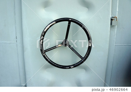 Black water tight handle of metal door on a ship 46902664