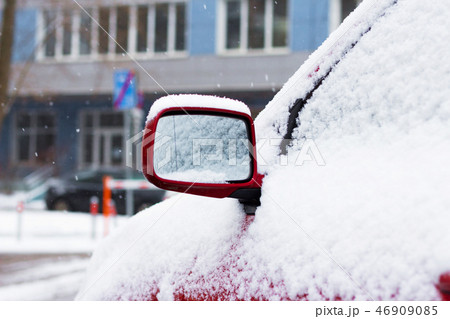 Snow-covered car on parking in winter Snow-covered car on parking in winter 46909085