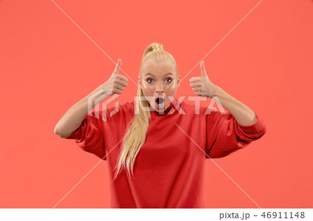 Beautiful woman looking suprised isolated on coral 46911148