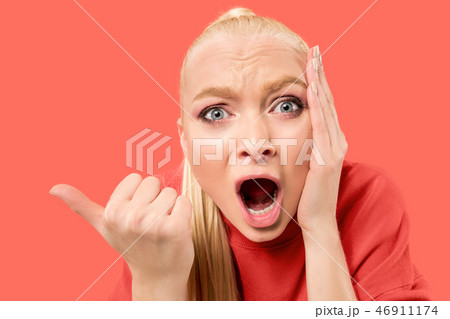 Beautiful woman looking suprised isolated on coral 46911174
