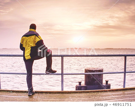 Man stand on mole and looking over sea 46911751