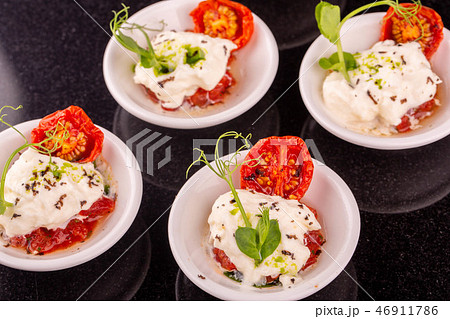 Tartlets from cheese mozzarella with tomatoes drie 46911786