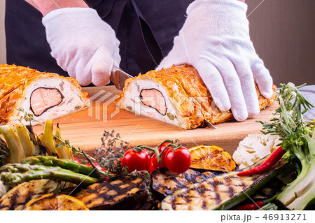 Cutting of a piece from fish pie for giving 46913271