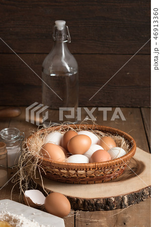 fresh eggs in the basket and bottle of water  46913360