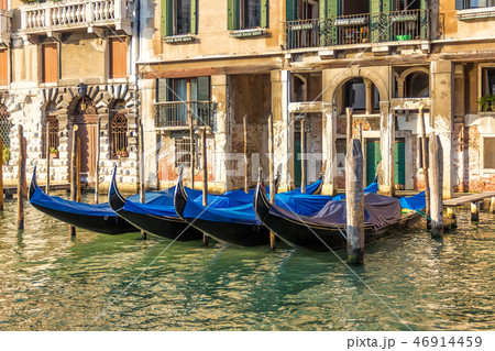 Venice palace with gondolas moored, Grand Canal, Italy 46914459