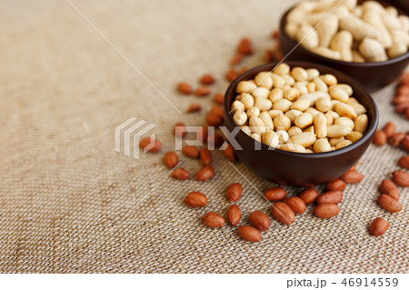 Peanuts in the shell and peeled closeup in a cup Peanuts in the shell and peeled closeup in a cup 46914559