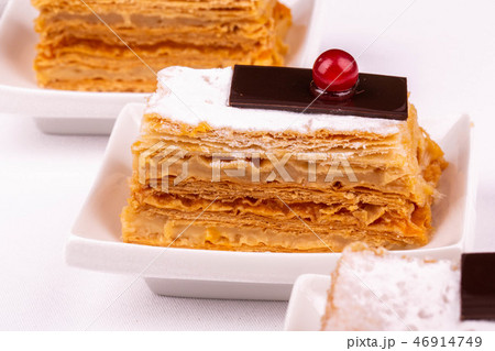 Napoleon in icing sugar with a piece of dark choco Napoleon in icing sugar with a piece of dark choco 46914749