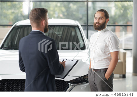 Manager selling client auto in car center. Manager selling client auto in car center. 46915241