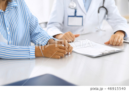 Doctor and patient talking and discussing health treatment while sitting at the desk. Medicine and 46915540