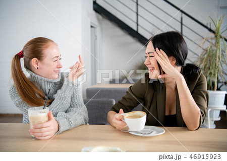 women giving rude middle finger hand gesture to her best friend having fun 46915923