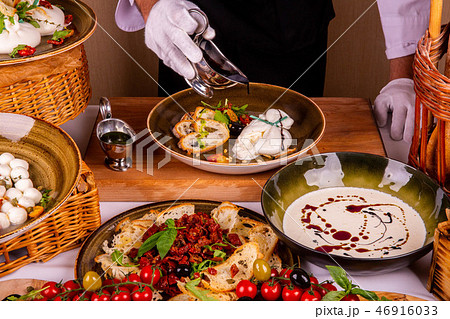 Cheese in sauce of two types is served on a plate Cheese in sauce of two types is served on a plate 46916033