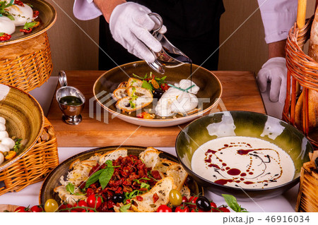 Sauce plum with cheese and greens is served on a p Sauce plum with cheese and greens is served on a p 46916034