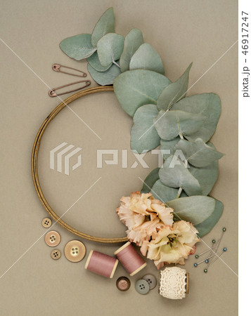 Flowers and leaves near embroidery supplies. Flowers and leaves near embroidery supplies. 46917247