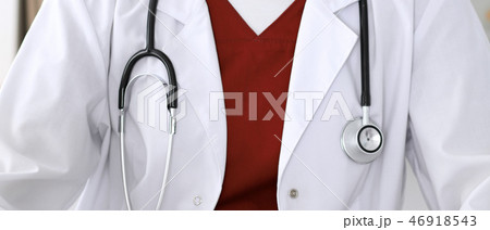 Close-up of a female doctor filling up  an application form while consulting patient 46918543