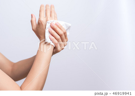 Woman cleaning hands with white soft tissue paper 46919941