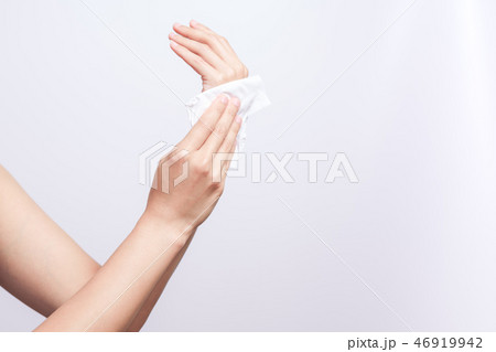 Woman cleaning hands with white soft tissue paper 46919942