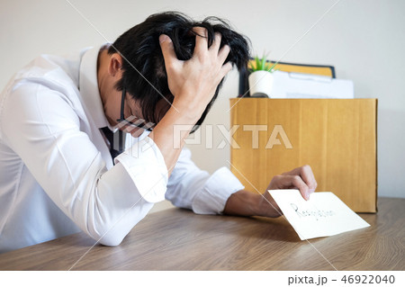 Stressed businessman will being resignation and packing belongin Stressed businessman will being resignation and packing belongin 46922040