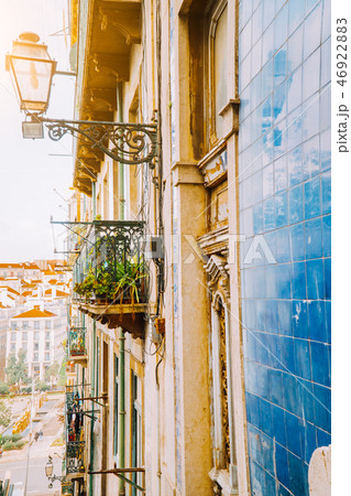 Traditional facade front of portuguese buildings with balconys and lamps. Old charming street in Traditional facade front of portuguese buildings with balconys and lamps. Old charming street in 46922883