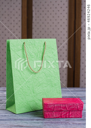 Green shopping bag and pink gift box. 46924246
