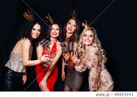 Four young beautiful women together celebrating party Four young beautiful women together celebrating party 46924341