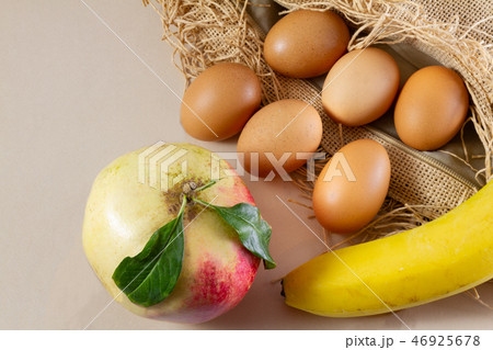 Six eggs one pomegranate one banana on sackcloth 46925678
