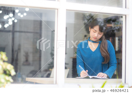Beautiful asian woman writer writing on notebook Beautiful asian woman writer writing on notebook 46926421