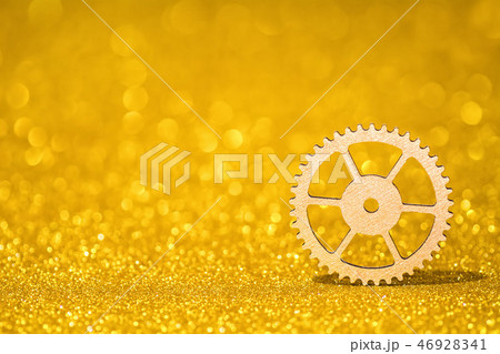 Shining gear on a golden radiant background. Glitter shine with 3d shape Shining gear on a golden radiant background. Glitter shine with 3d shape 46928341