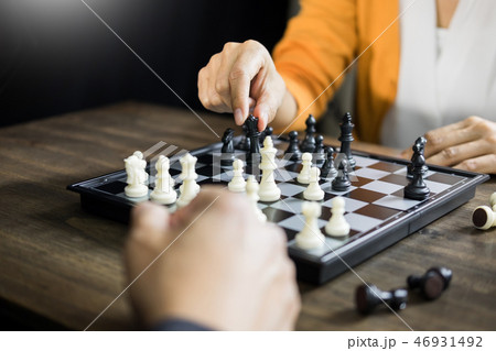 hand of businessman moving chess figure in competition board gam hand of businessman moving chess figure in competition board gam 46931492
