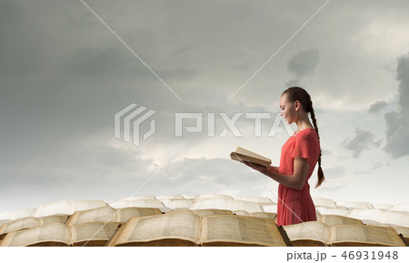 Girl holding opened book Girl holding opened book 46931948