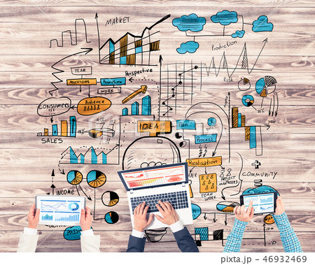 Top view of businesspeople sitting at table and using gadgets Top view of businesspeople sitting at table and using gadgets 46932469