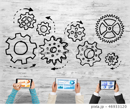 Top view of businesspeople sitting at table and using gadgets Top view of businesspeople sitting at table and using gadgets 46933120