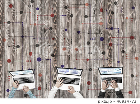 Top view of businesspeople sitting at table and using gadgets Top view of businesspeople sitting at table and using gadgets 46934772