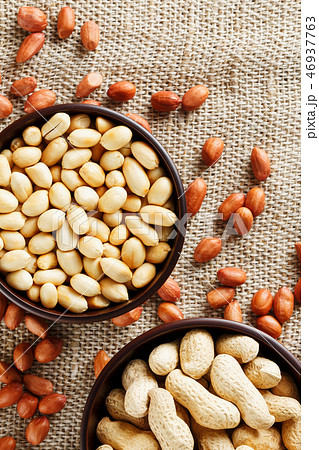 Peanuts in the shell and peeled closeup in a cup Peanuts in the shell and peeled closeup in a cup 46937763