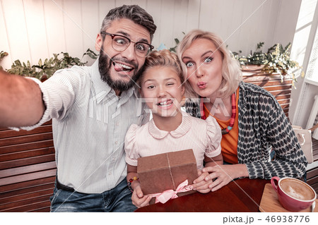 Joyful positive family taking a funny photo 46938776