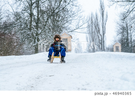 Boy with a sled at winter country Boy with a sled at winter country 46940365